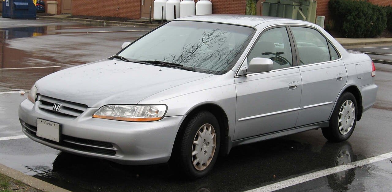Silver 2001 to 2002 Honda Accord sedan parked on wet pavement