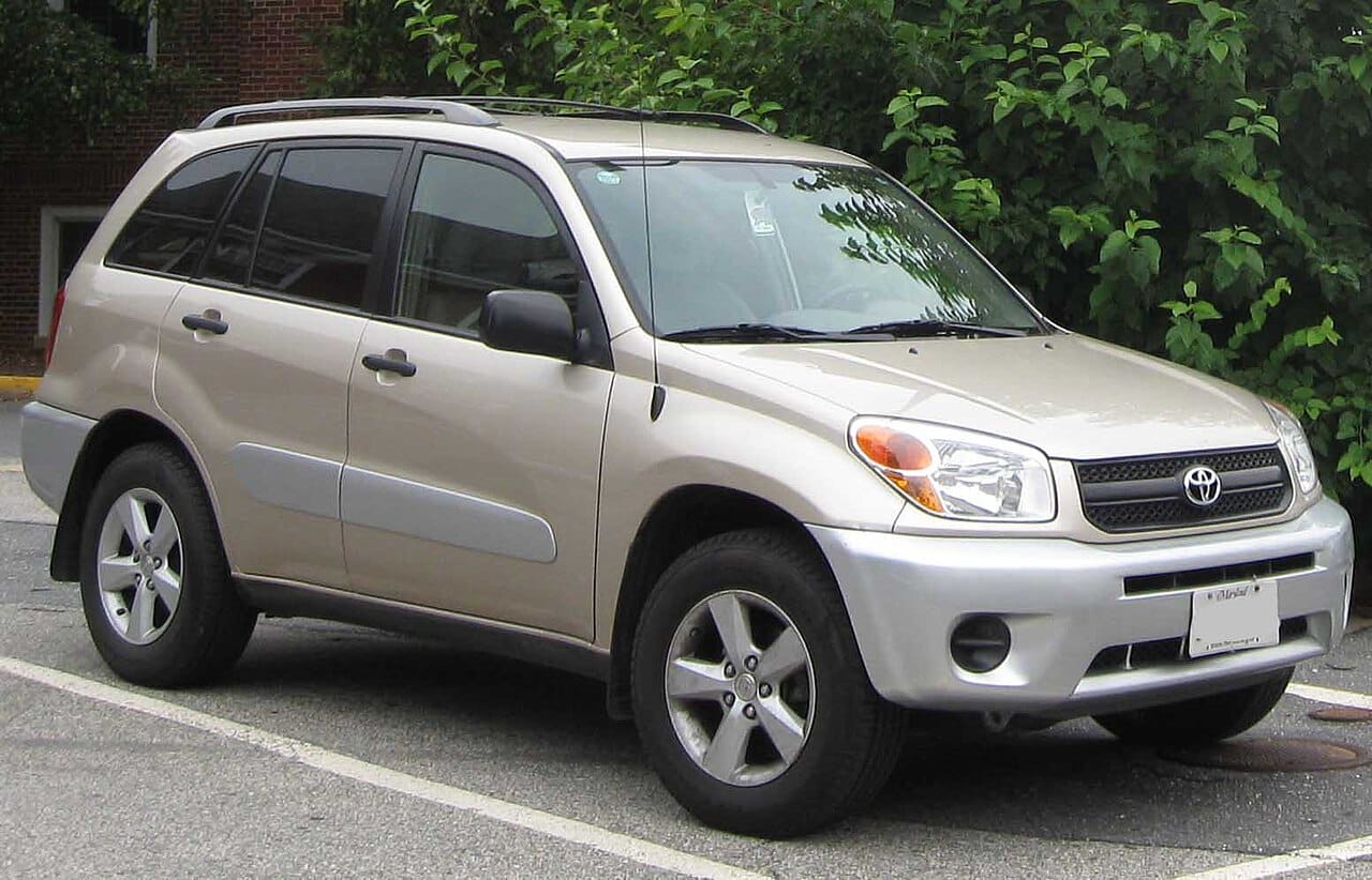Silver 2004 to 2005 Toyota RAV4 compact SUV parked near greenery