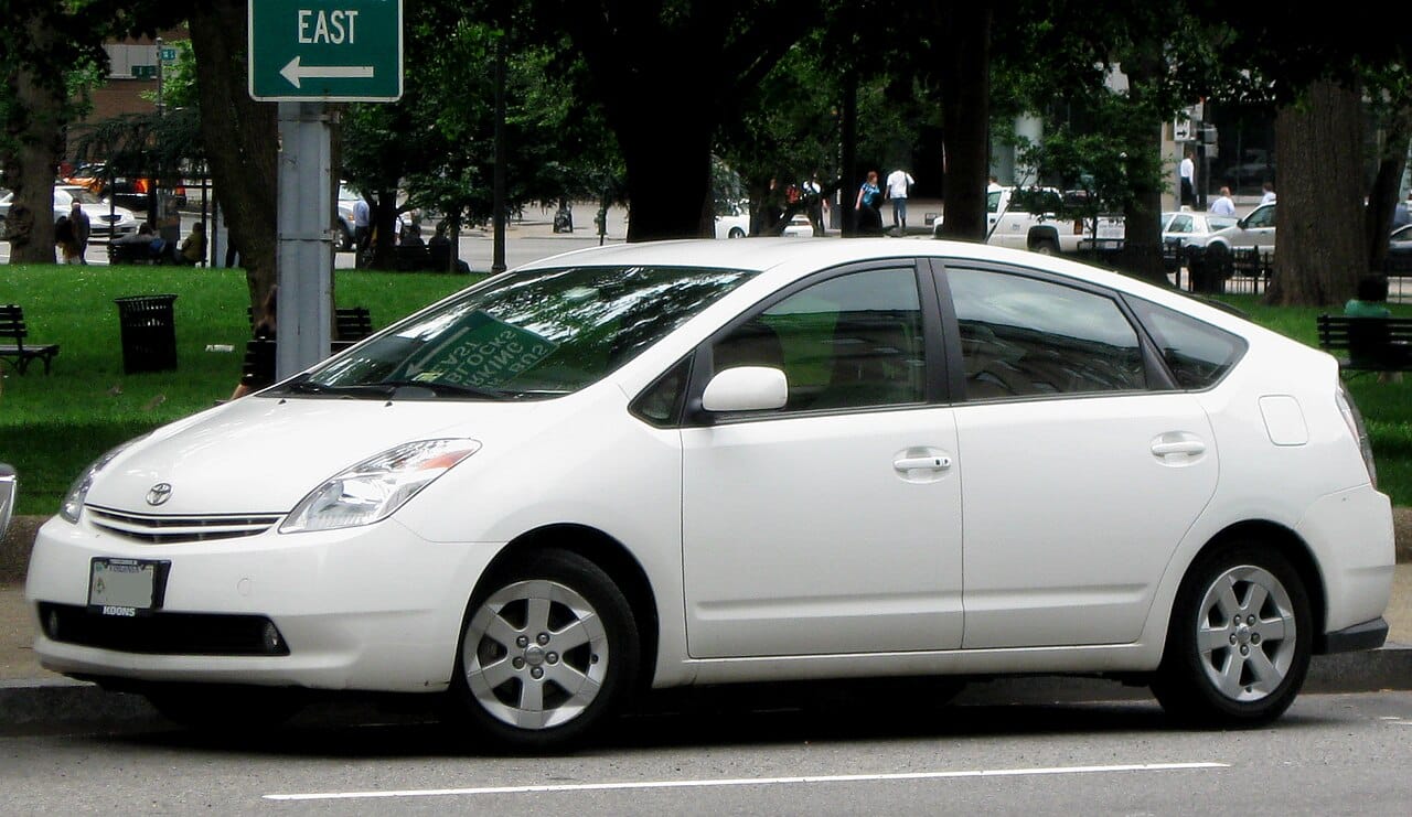 White 2004 to 2009 Toyota Prius hybrid parked on a city street