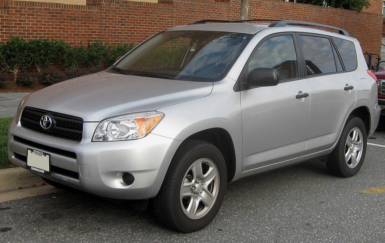 Silver 2006 to 2008 Toyota RAV4 compact SUV parked beside a brick wall