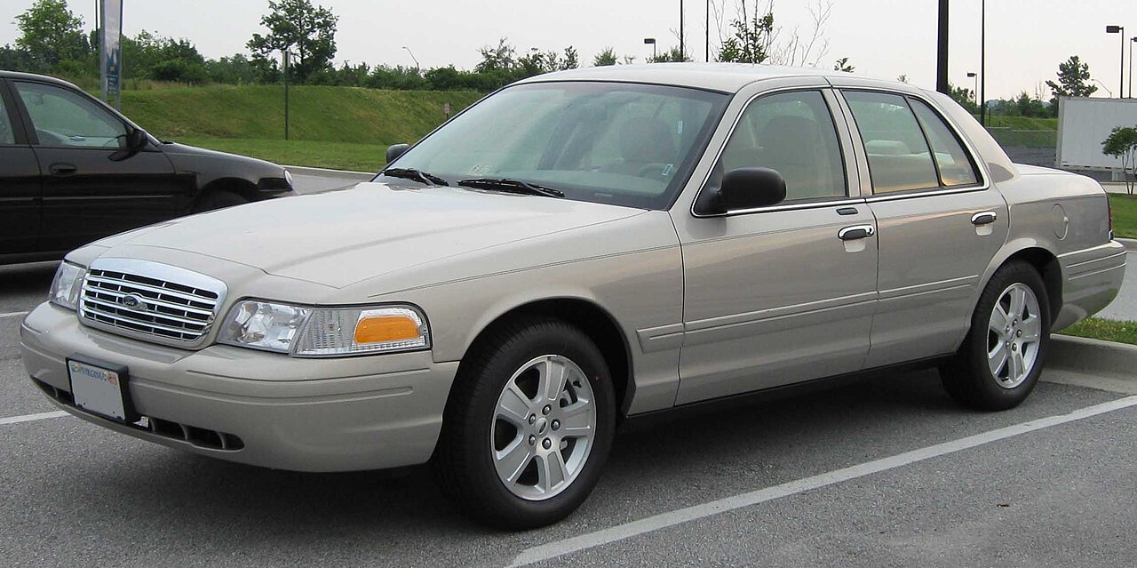Beige 2007 Ford Crown Victoria LX sedan parked in a lot