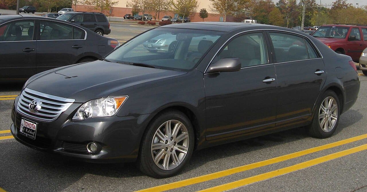 Dark gray 2008 Toyota Avalon sedan parked in a shopping center lot