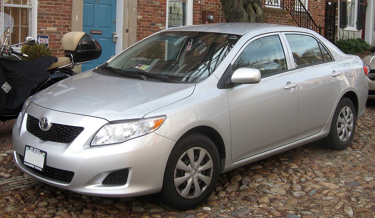 Silver 2009 Toyota Corolla LE sedan parked on a cobblestone street