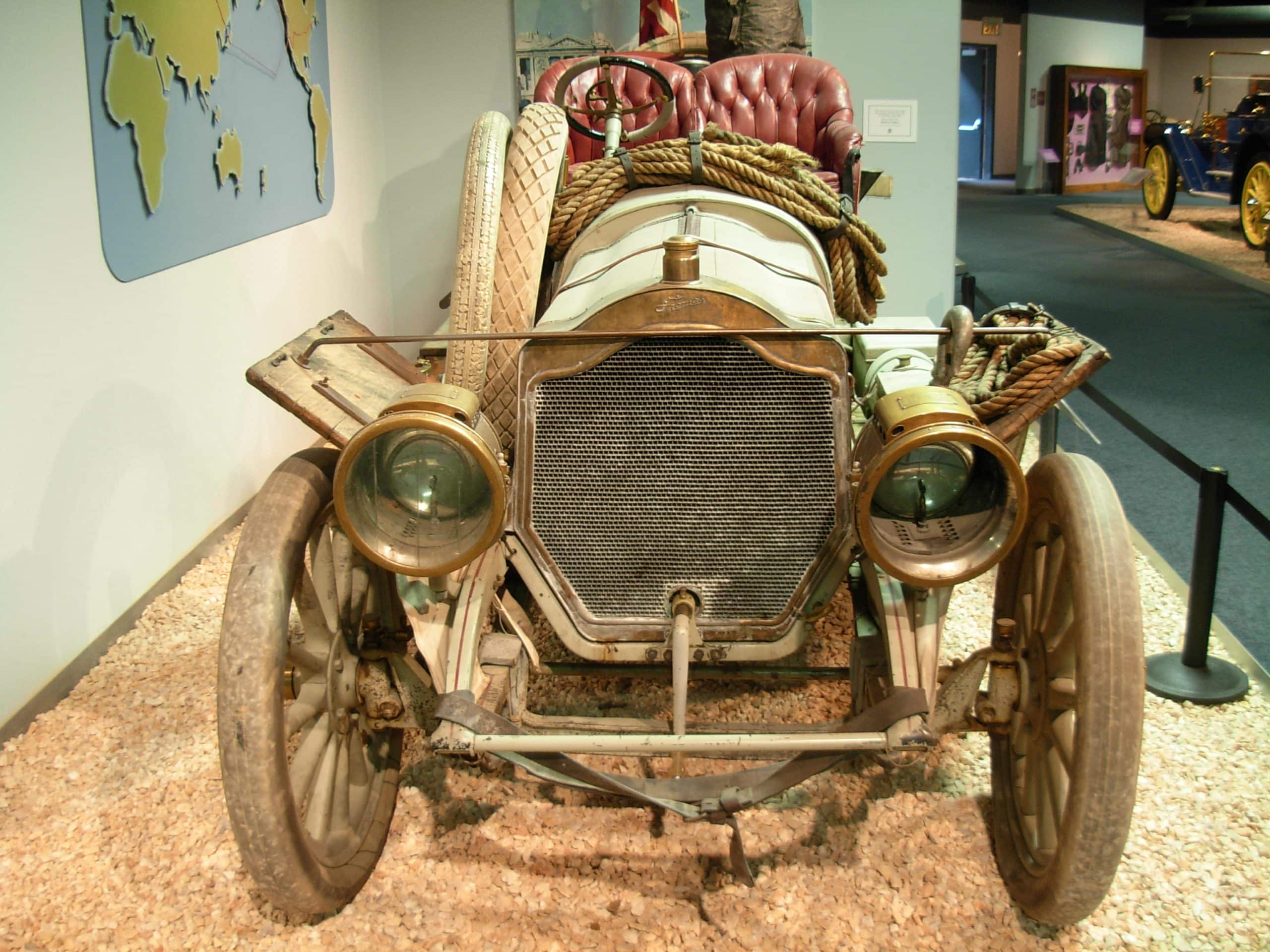 1907 Thomas Flyer displayed in a museum with its large front engine compartment