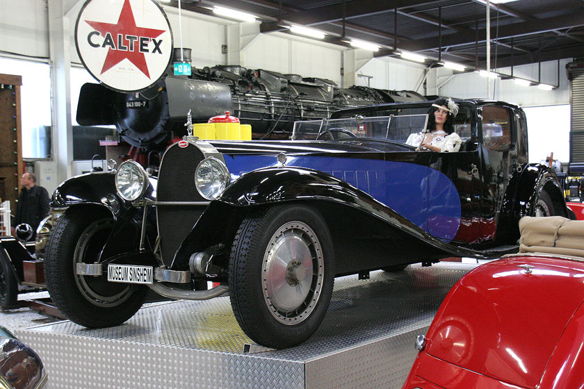 Blue and black Bugatti Type 41 Royale displayed in a museum