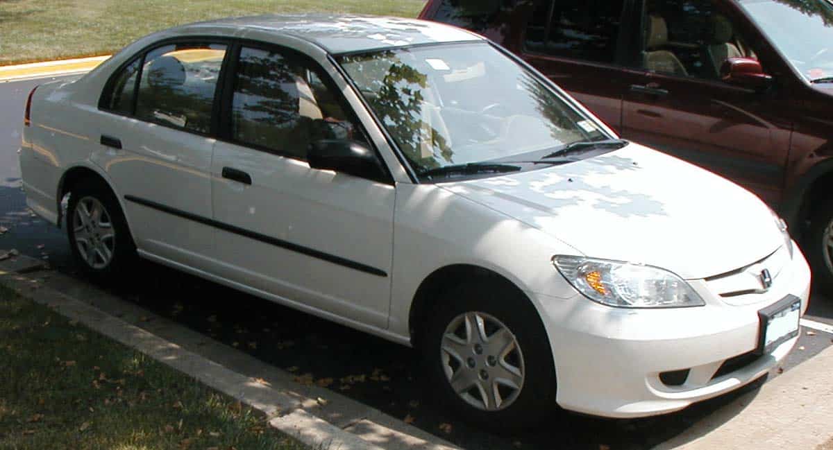 White 2004 to 2005 Honda Civic sedan parked beneath trees