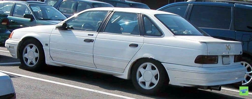 White first-generation Ford Taurus SHO viewed from the rear side