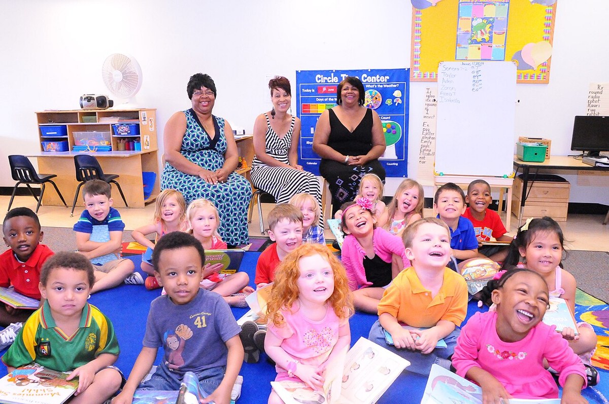 Child development center teachers and children participating in a read-a-thon
