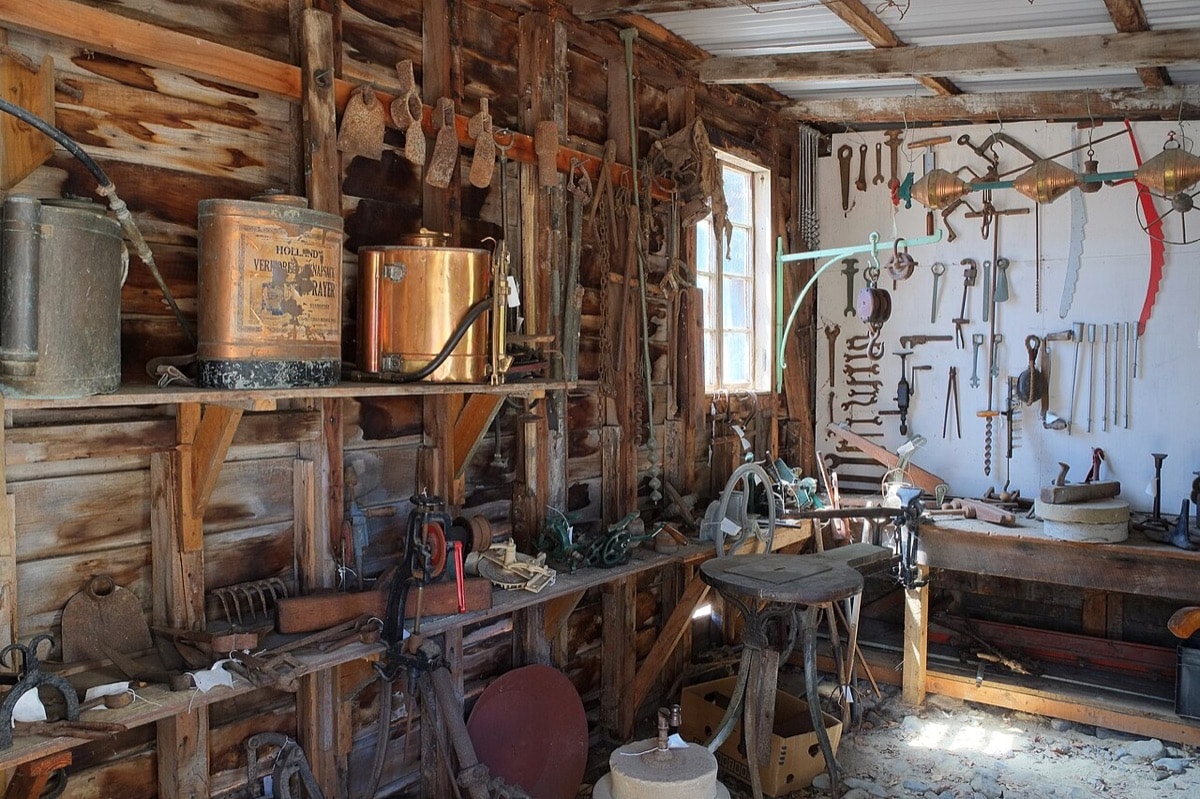Old tools, shelves, and workbenches inside the workshop at Cobblestones Museum