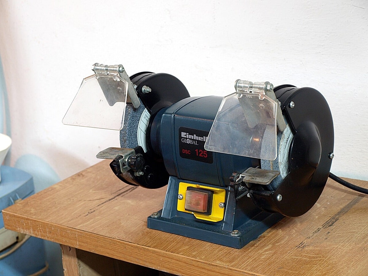 Einhell bench grinder with two grinding wheels and eye shields