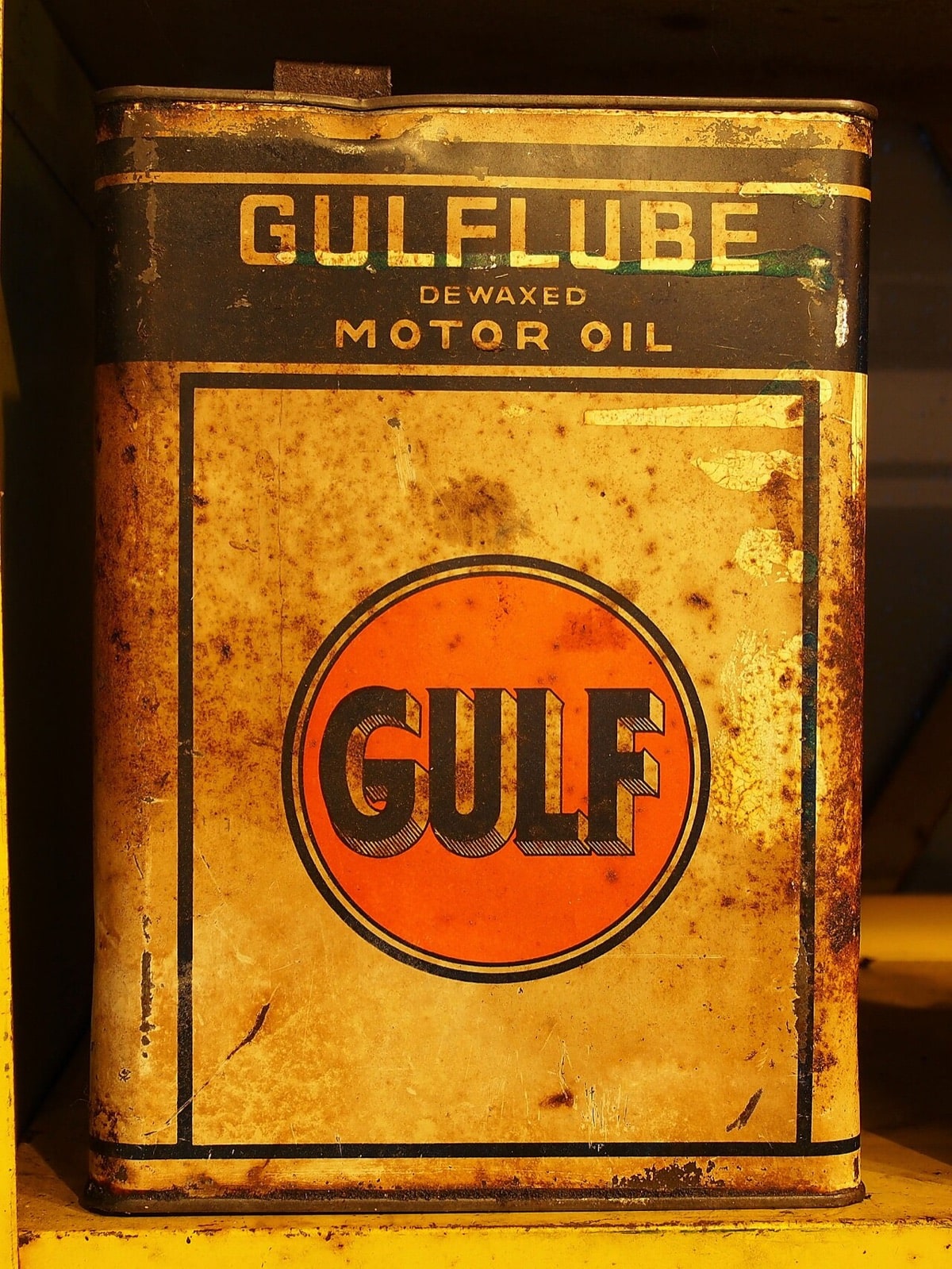 Weathered yellow Gulflube motor-oil tin with orange Gulf logo