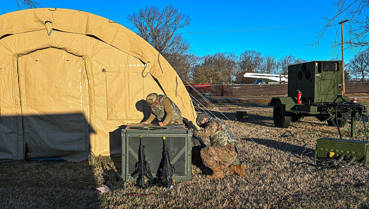 Air Force HVAC technicians repairing an environmental control unit