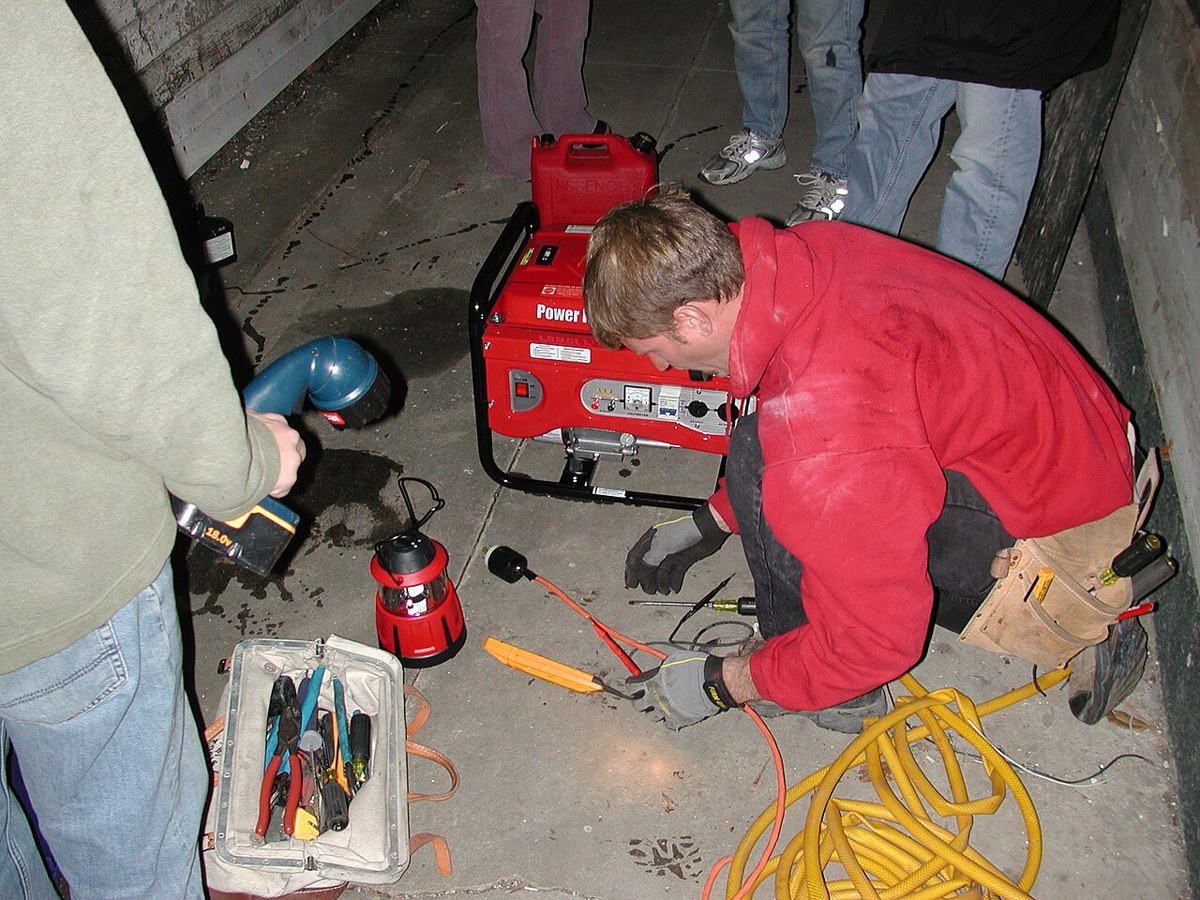 Electrician connecting equipment while installing a home generator