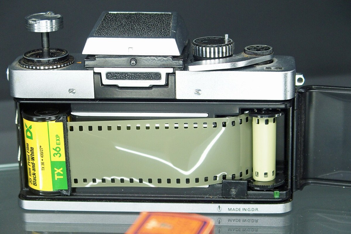Open back of a 35mm SLR camera showing film engaged on the spool