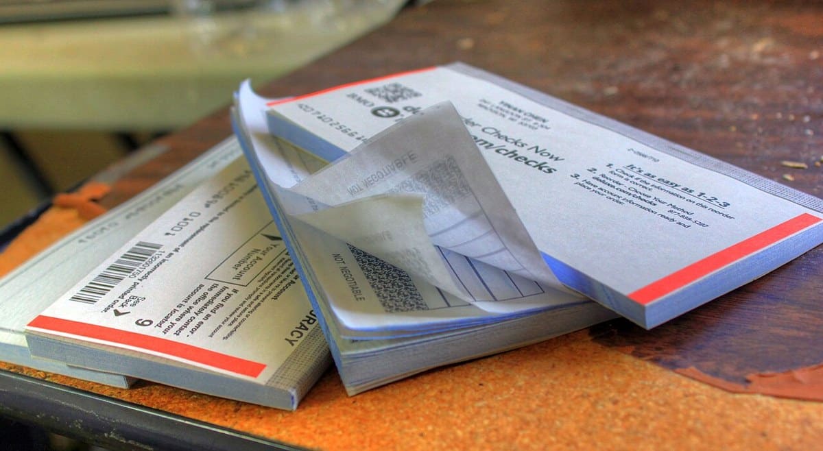 Paper checkbooks resting on a desk