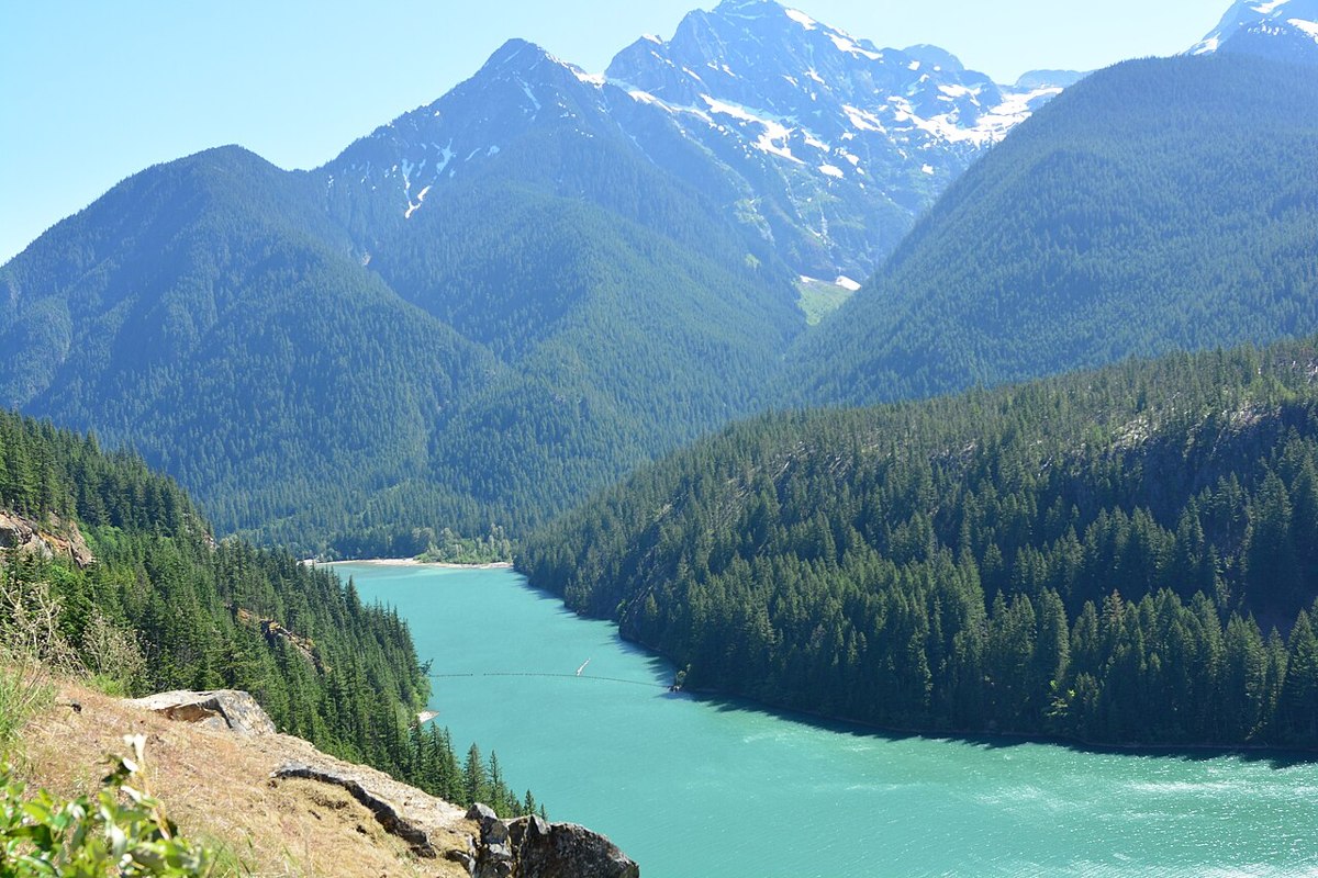 Turquoise Diablo Lake below forested ridges and Colonial Peak