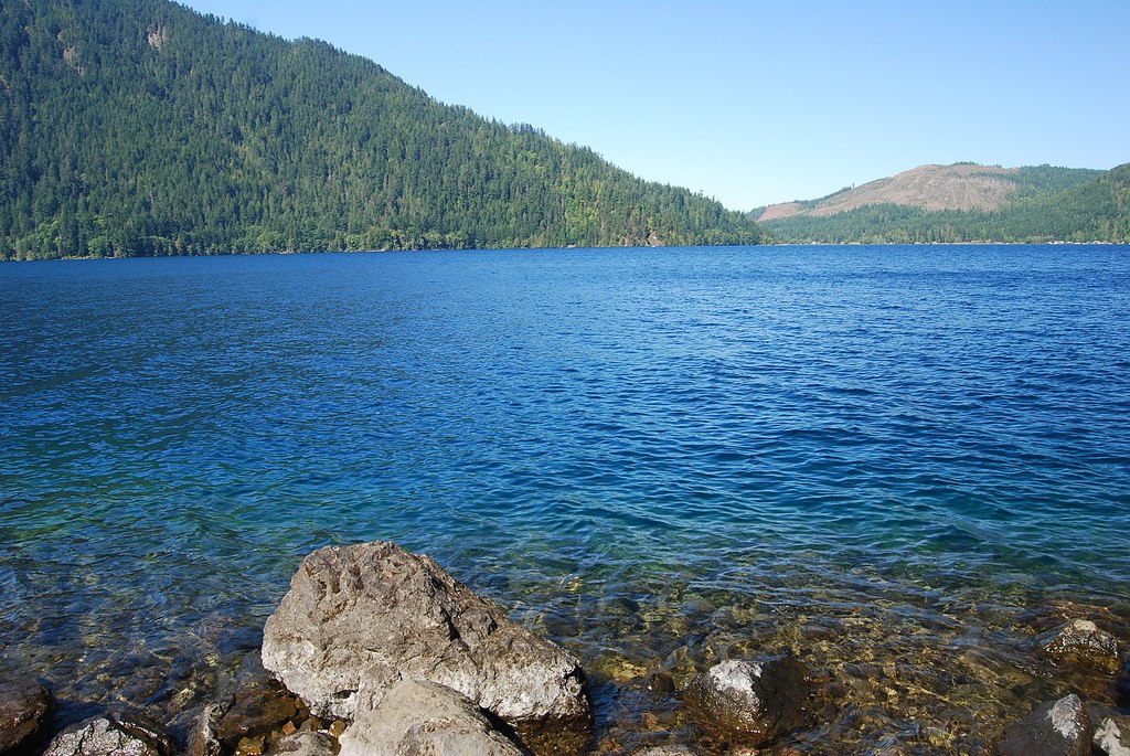 Blue Lake Crescent beneath steep forested mountains