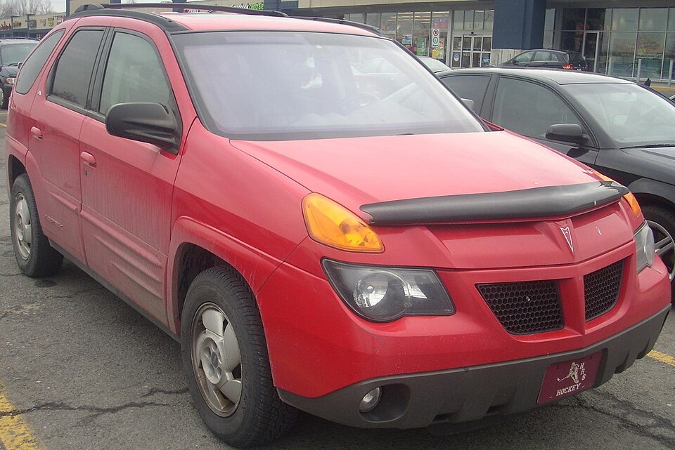Red 2001 Pontiac Aztek showing its split front lighting
