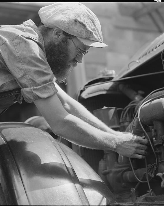 A mechanic working under the hood in Benton Harbor, Michigan, July 1940.