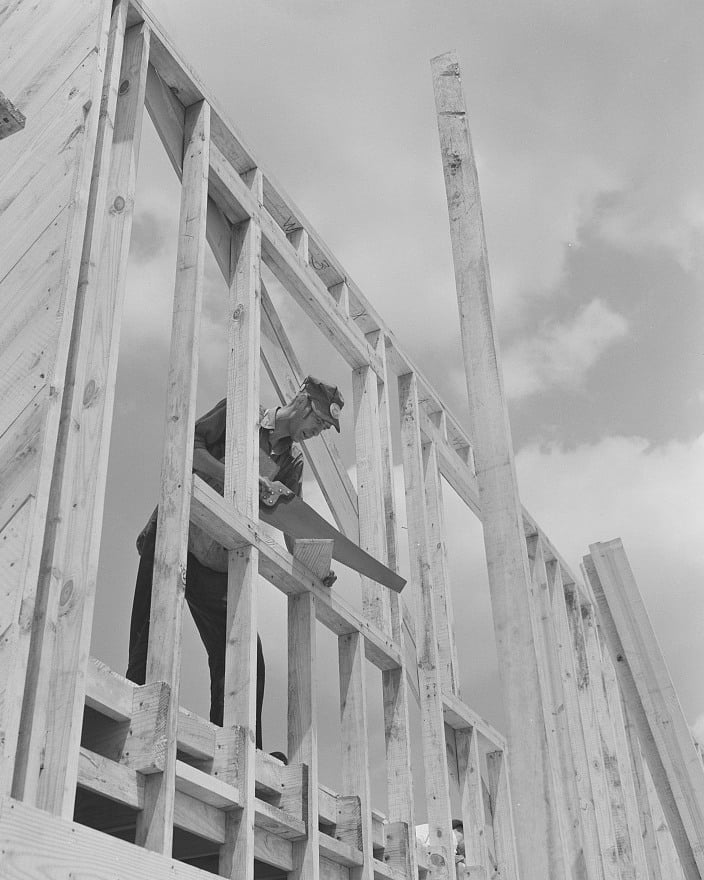 A carpenter using a handsaw on a housing project in Erie, Pennsylvania, July 1941.