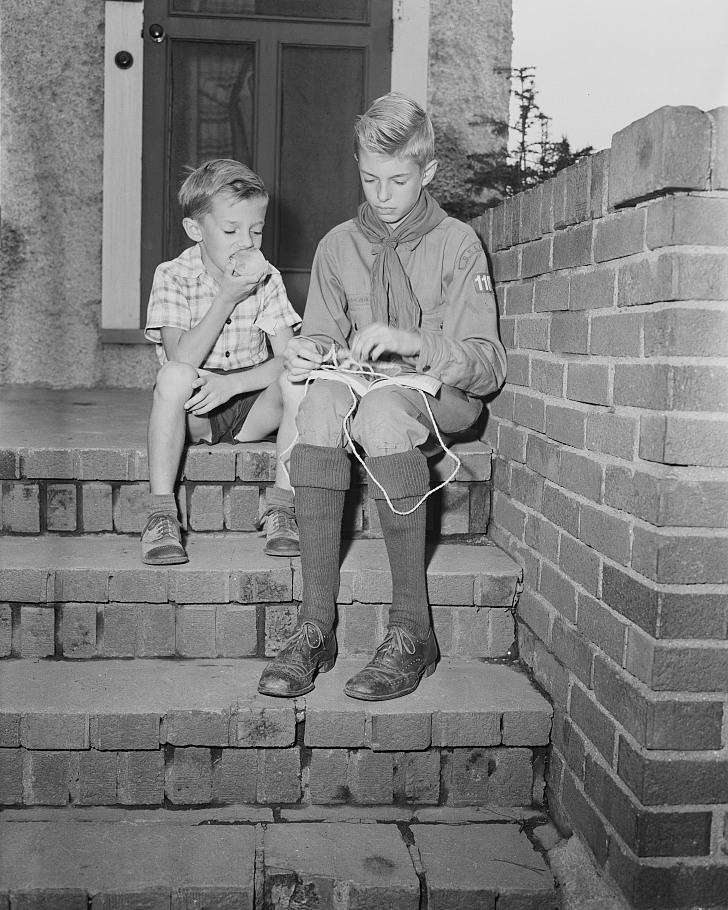 Howard Babcock practicing knots while his brother Earl watches, Rochester, 1943.