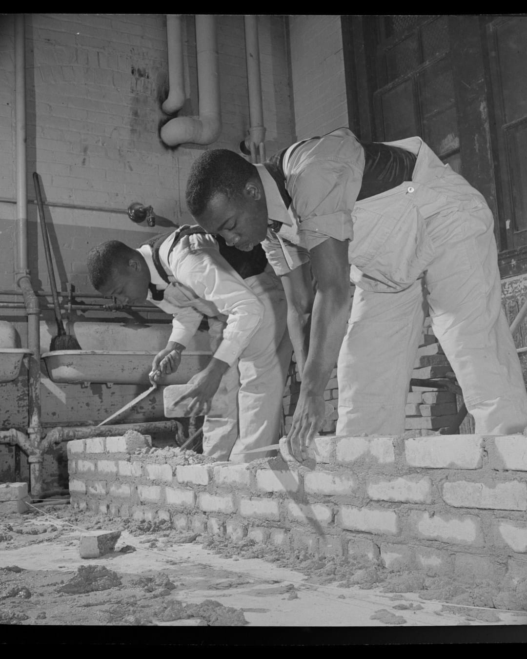Students practice laying a brick wall at Armstrong Technical High School in 1942
