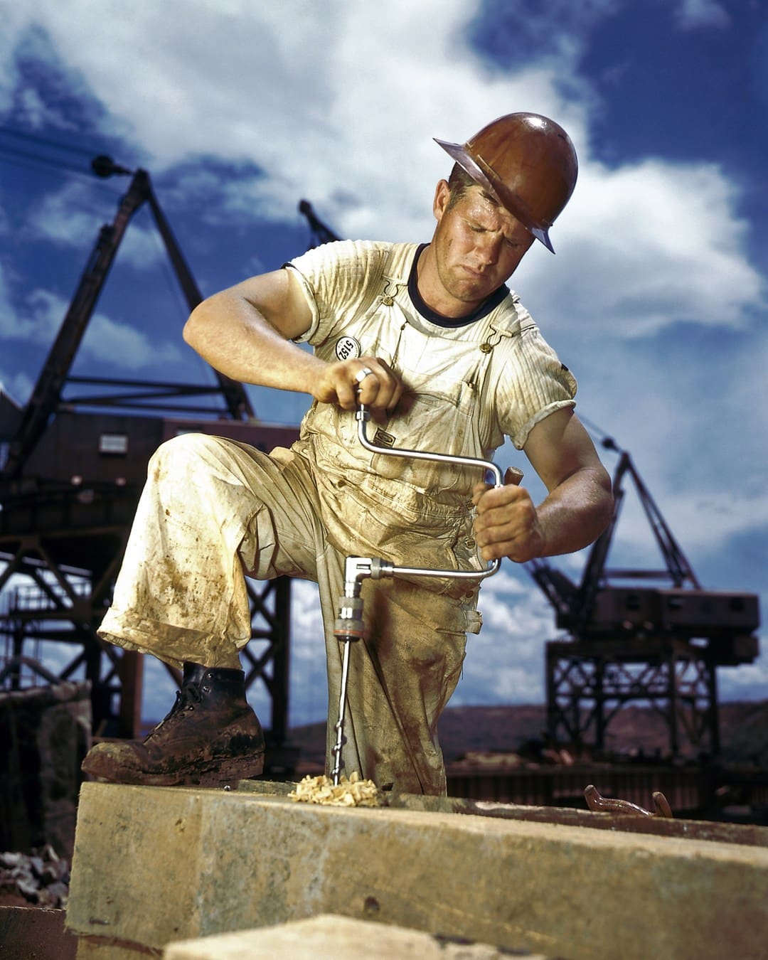 A carpenter turns a brace and bit at Douglas Dam in Tennessee in 1942