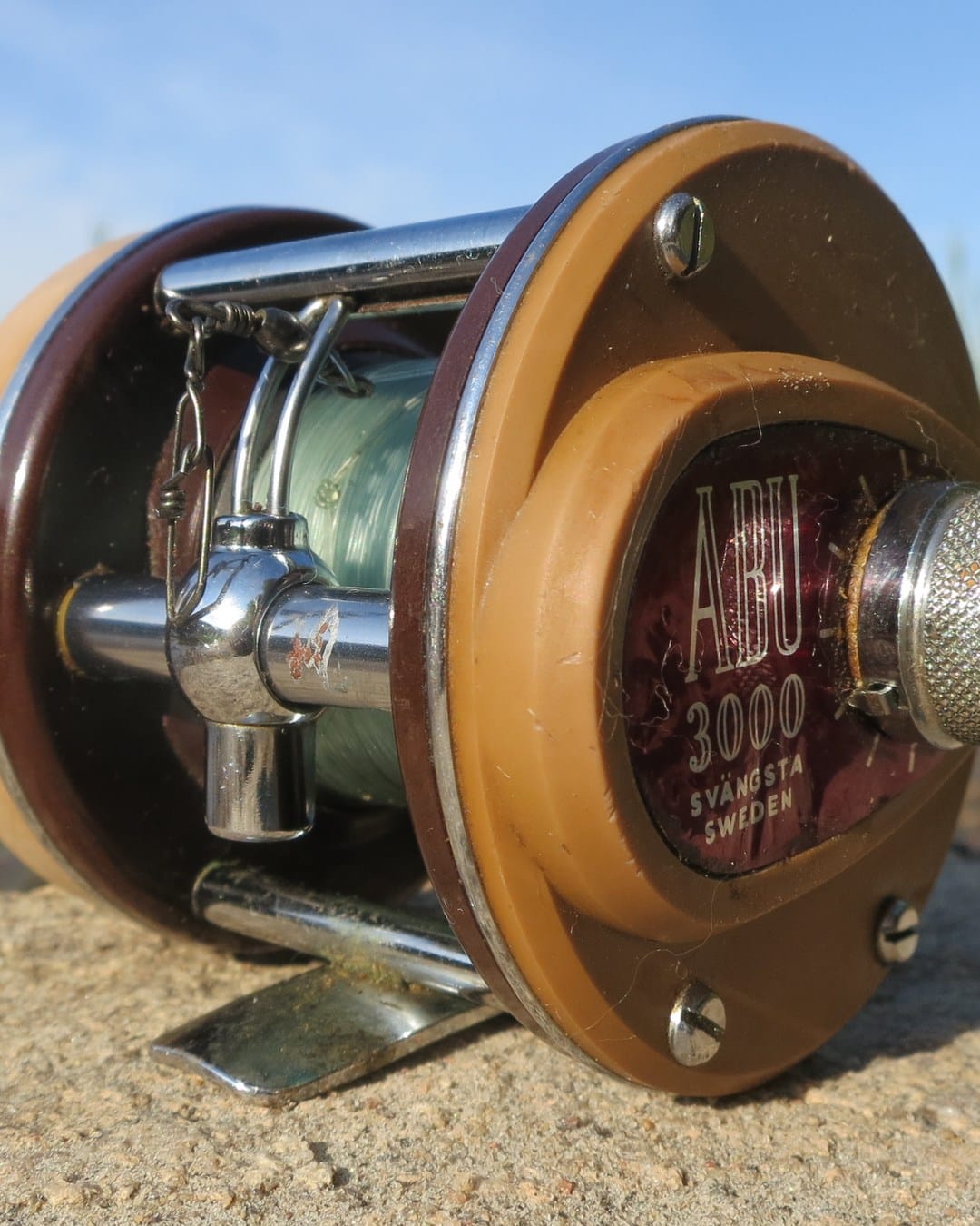 A well-used 1965 ABU 3000 fishing reel in a recent close-up photograph