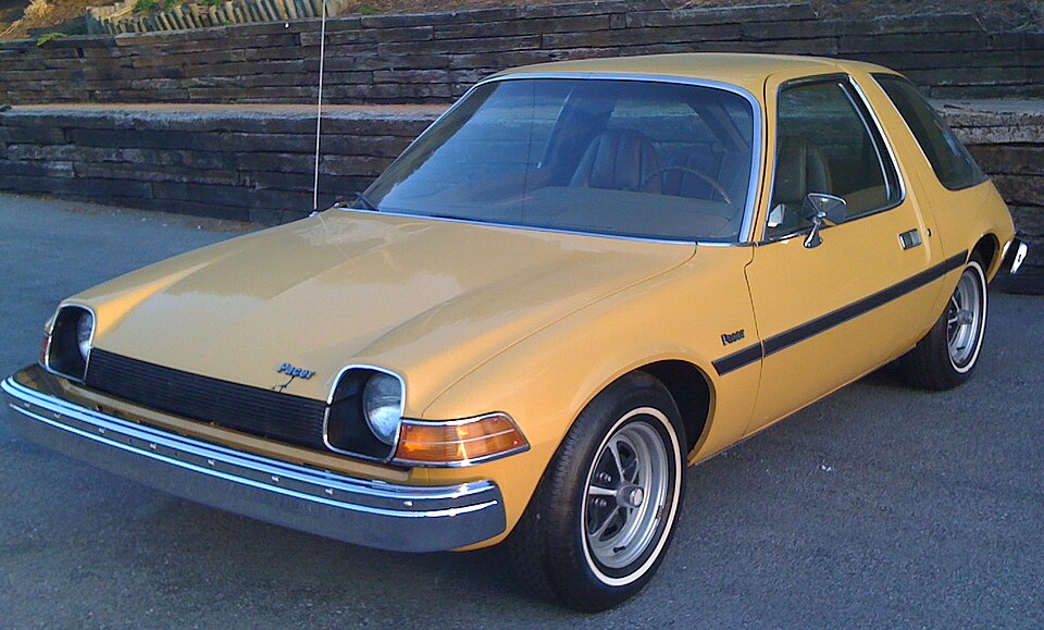 Yellow 1975 AMC Pacer viewed from the front and side