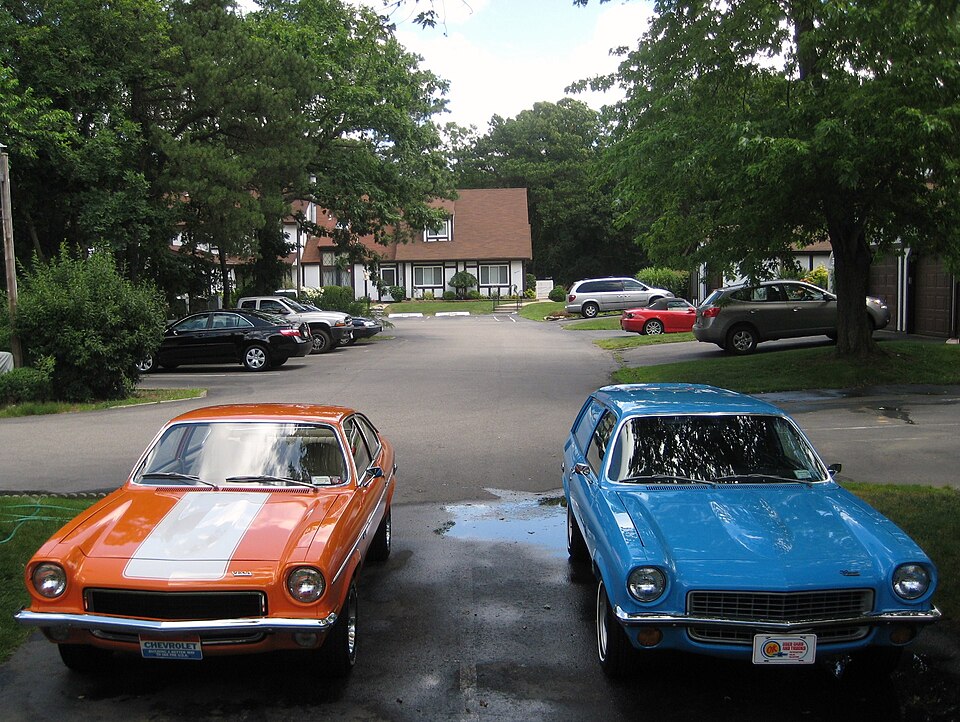 Front views of an orange 1973 Chevrolet Vega and a blue 1971 Vega
